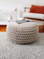 Round beige crocheted pouf