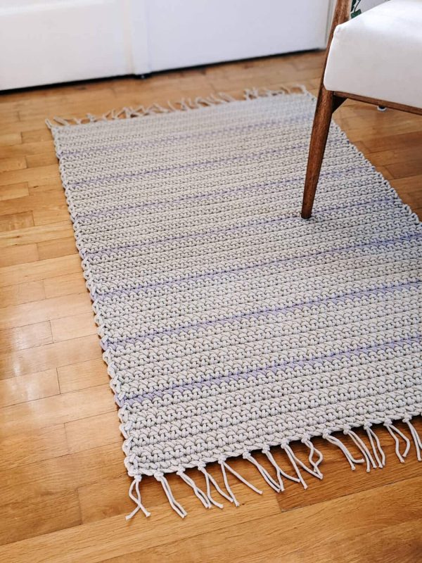Crocheted beige with lila stripes rug