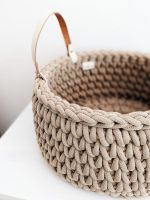 Beige crocheted storage basket with handles