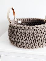 Brown crocheted storage basket with handles