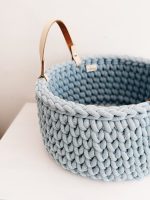 Blue crocheted storage basket with handles